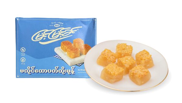 A blue Myint Myint Khin box of မလိုင်ထောပတ်ထိုးမုန့် beside a gold-rimmed plate of six translucent squares with toasted golden tops